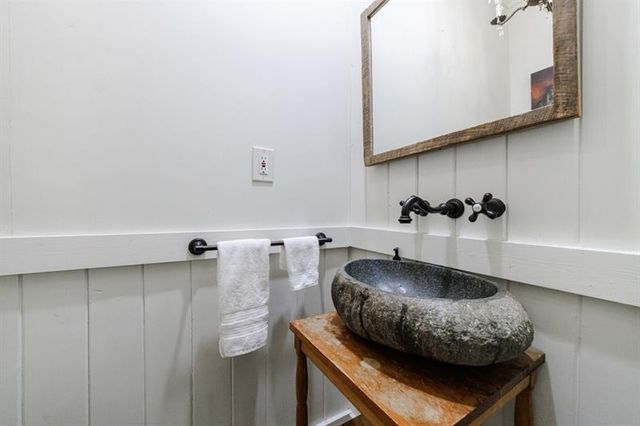 a bedroom with a large bed and a chandelier