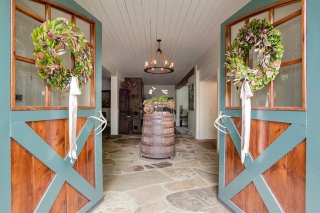 a view of a hallway with living room and dining room