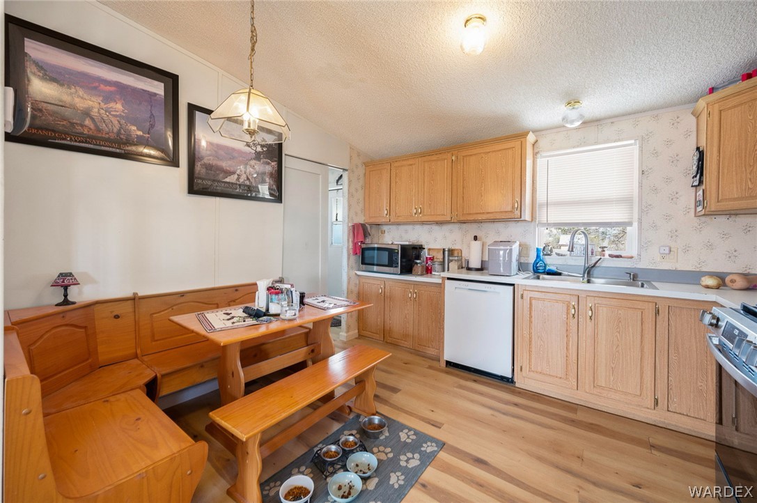 2465 Egar Road Golden Valley, AZ 86413 - Photo 24 of 98 Kitchen featuring wood-look flooring, light wood cabinetry, white countertops, and a built-in booth dining area