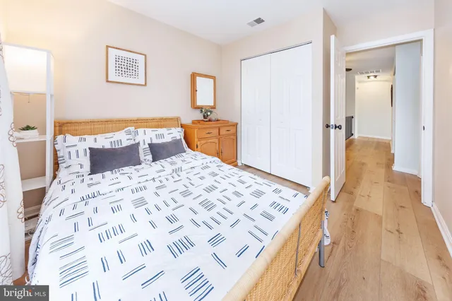 a bedroom with a bed and wooden floor