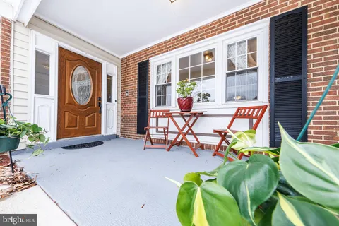 a view of a patio with table and chairs and potted plants
