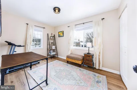 a view of a livingroom with furniture and a window