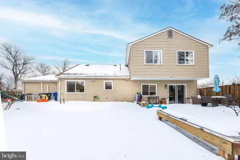 a view of a white house with swimming pool and sitting area