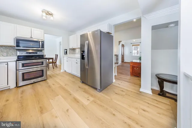 a kitchen with a sink appliances cabinets and a counter top space