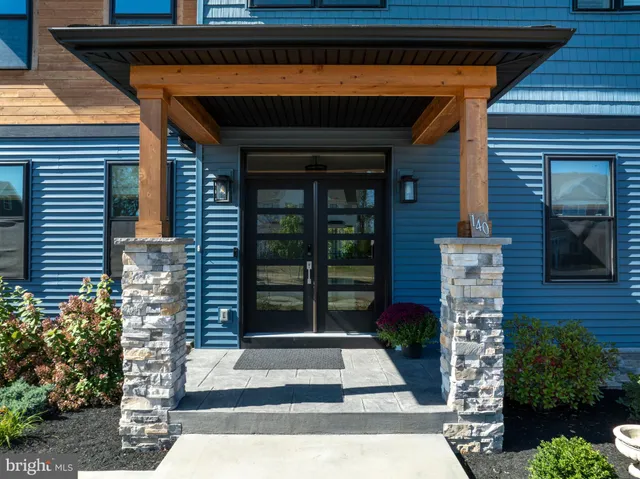 a view of a livingroom with wooden floor and window