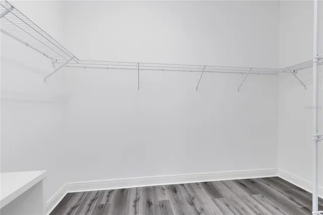 a view of walk in closet with empty racks