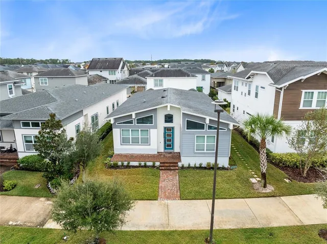 an aerial view of a house with a yard