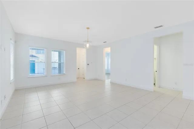 an empty room with large windows