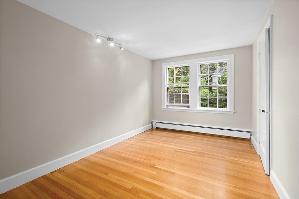 27 Conant Road Brookline, MA 02467 - Photo 16 of 23 an empty room with wooden floor and windows