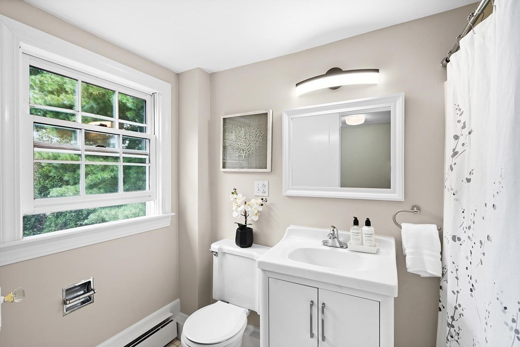 27 Conant Road Brookline, MA 02467 - Photo 17 of 23 a bathroom with a toilet sink and mirror