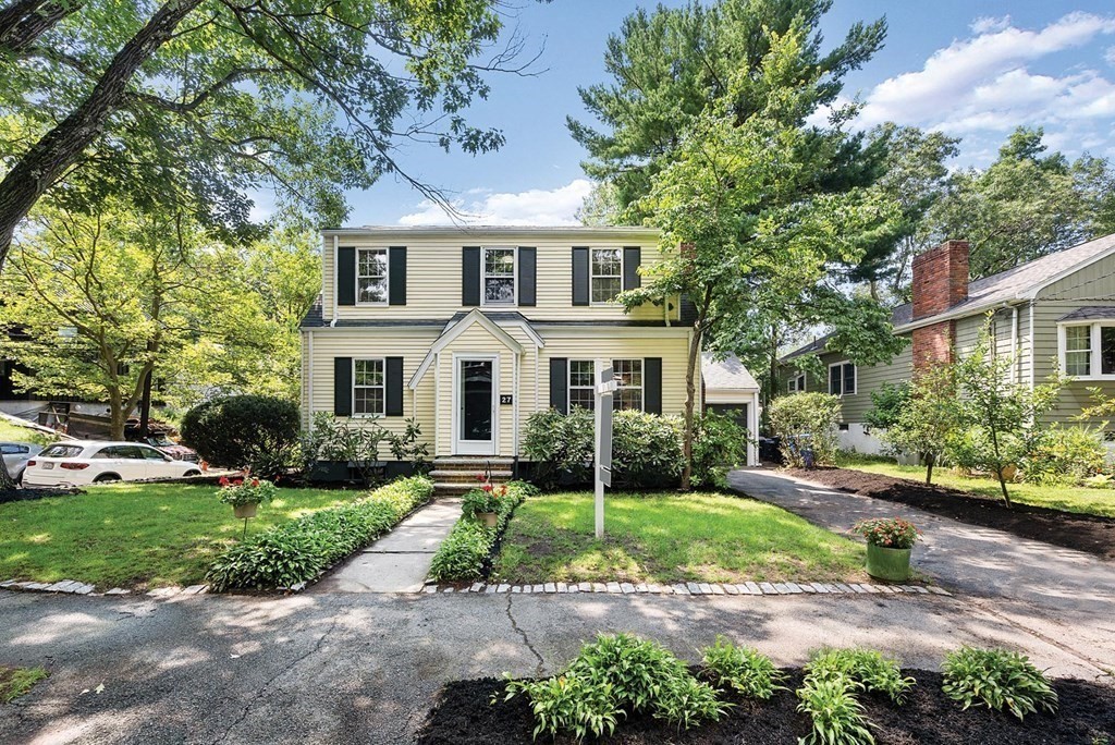 27 Conant Road Brookline, MA 02467 - Photo 23 of 23 a front view of a house with a garden and plants
