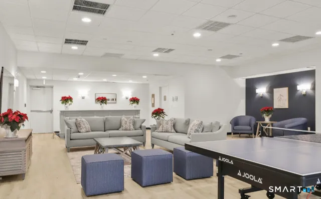 a living room with furniture and flowers