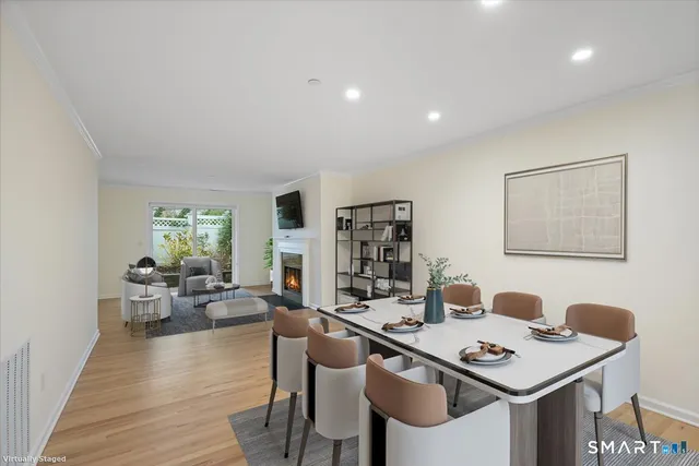 a view of a dining room with furniture window and wooden floor