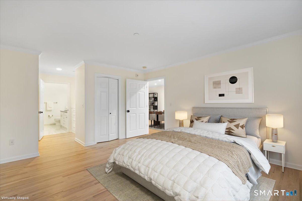 51 Forest Avenue Greenwich, CT 06870 - Photo 7 of 27 a spacious bedroom with a bed and a lamp