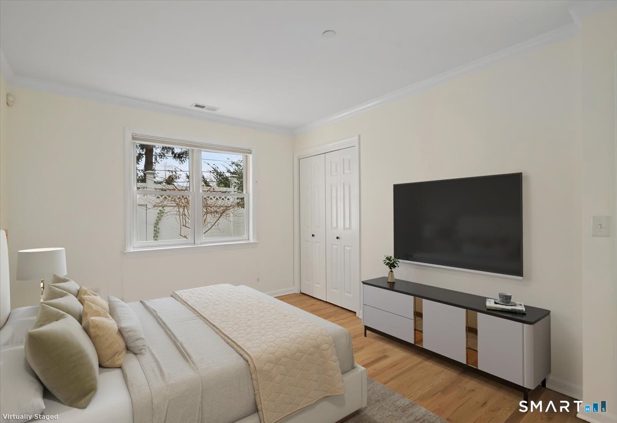 51 Forest Avenue Greenwich, CT 06870 - Photo 10 of 27 a bedroom with bed and flat screen tv