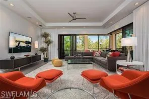 a living room with blue couches and a flat screen tv