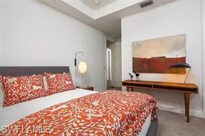 a bedroom with a bed and a dresser