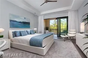 a bedroom with a bed and large windows