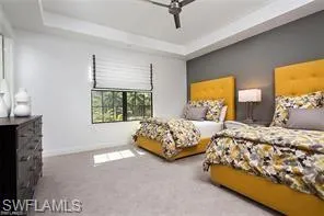 a bedroom with two beds and large windows