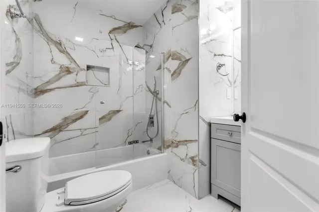 a bathroom with a toilet and a shower