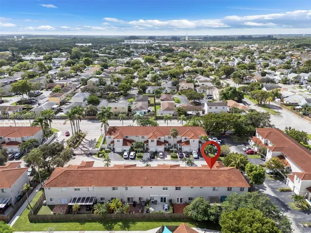an aerial view of residential houses with outdoor space