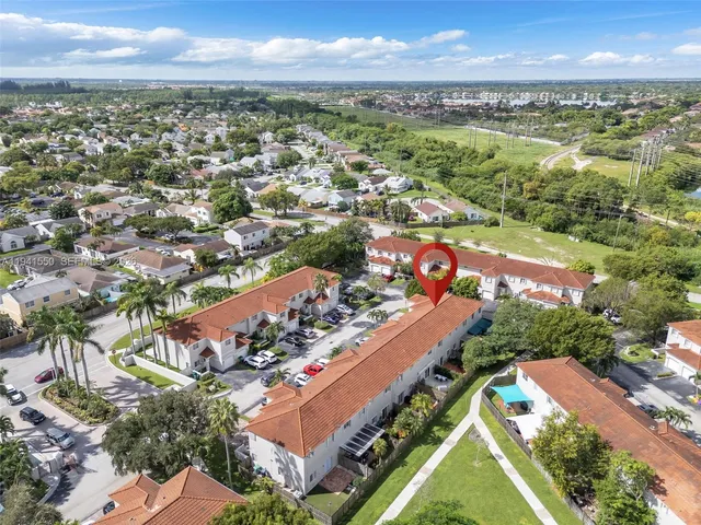 an aerial view of residential houses with outdoor space