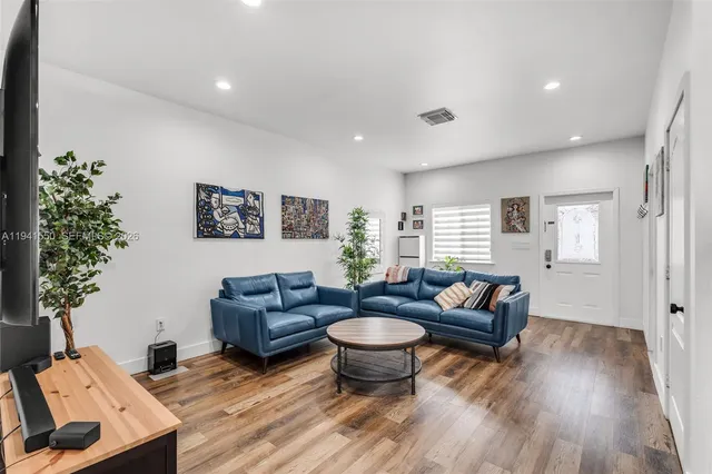 a living room with furniture and a potted plant
