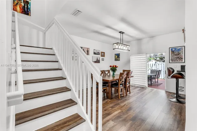 a view of a dining room with furniture and wooden floor