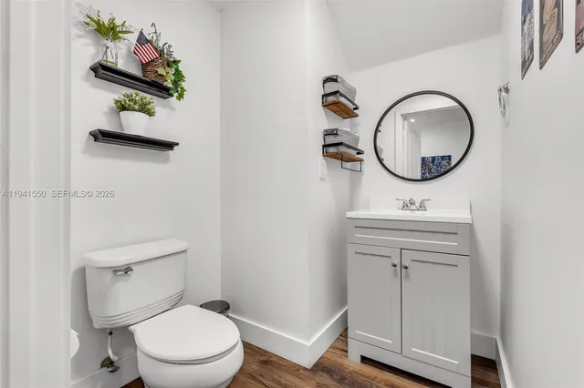 a bathroom with a toilet a sink and mirror