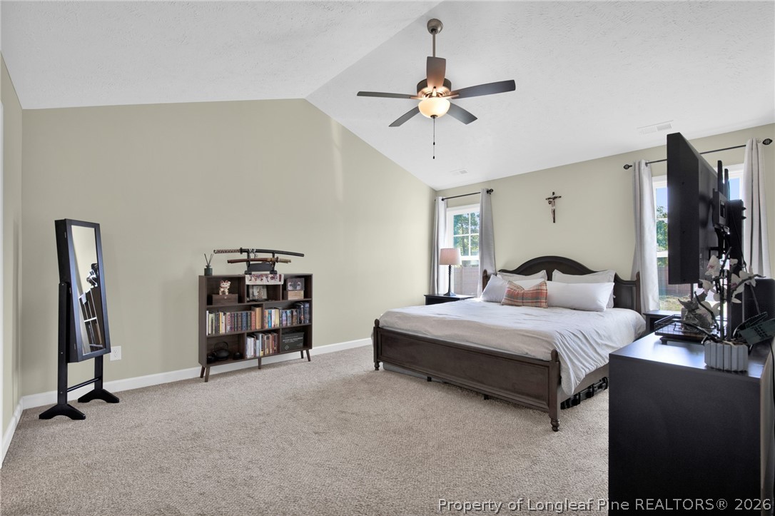 351 Sandy Grove Road Parkton, NC 28371 - Photo 19 of 30 a bedroom with bed and a chandelier