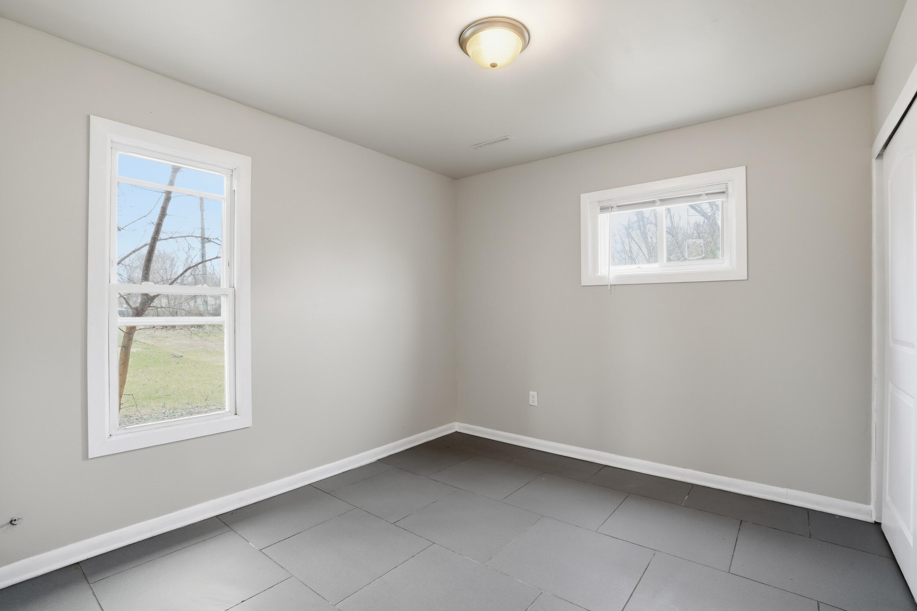 1075 Mount Street Gary, IN 46406 - Photo 2 of 11 an empty room with windows