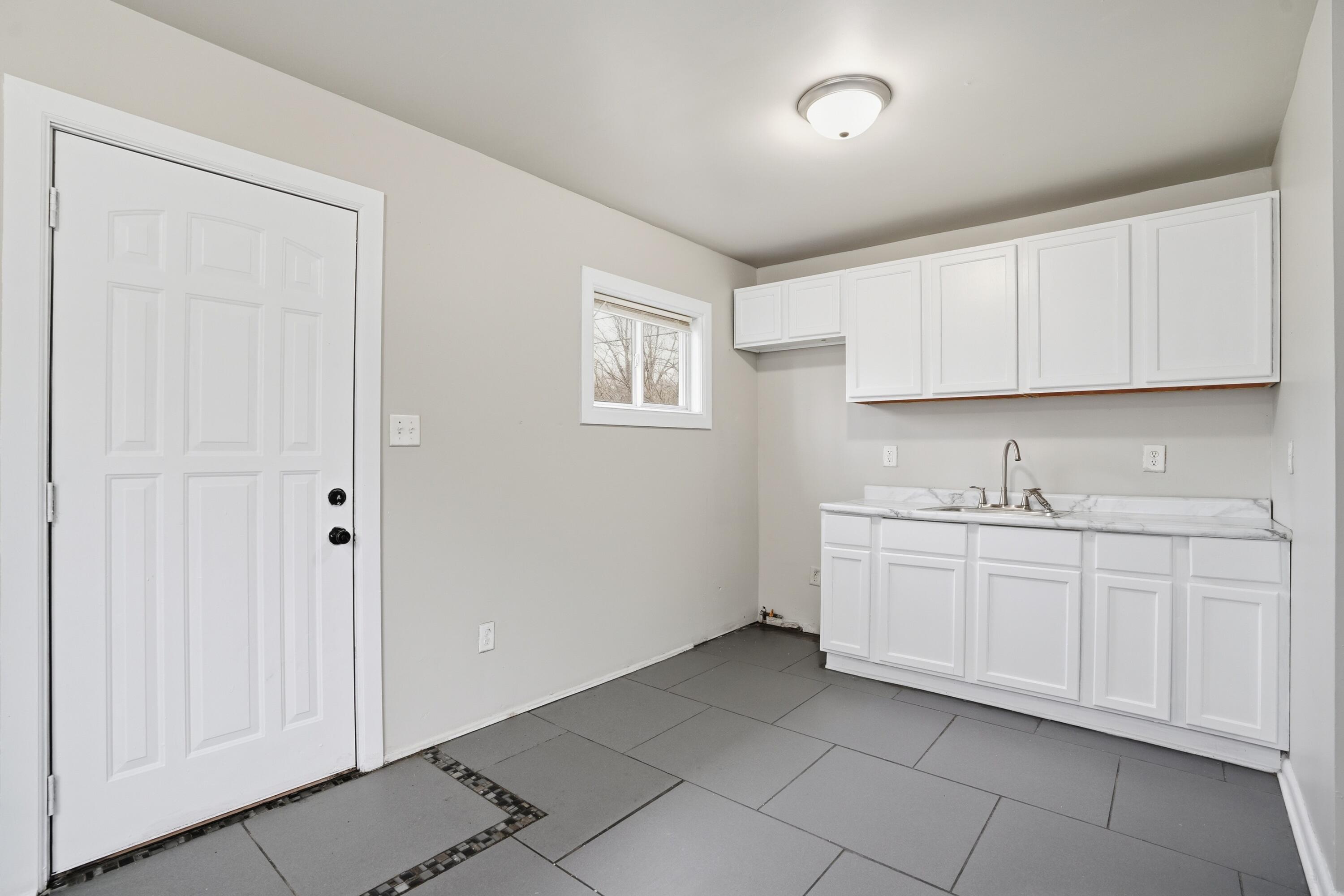 1075 Mount Street Gary, IN 46406 - Photo 9 of 11 a spacious bathroom with a sink and a mirror
