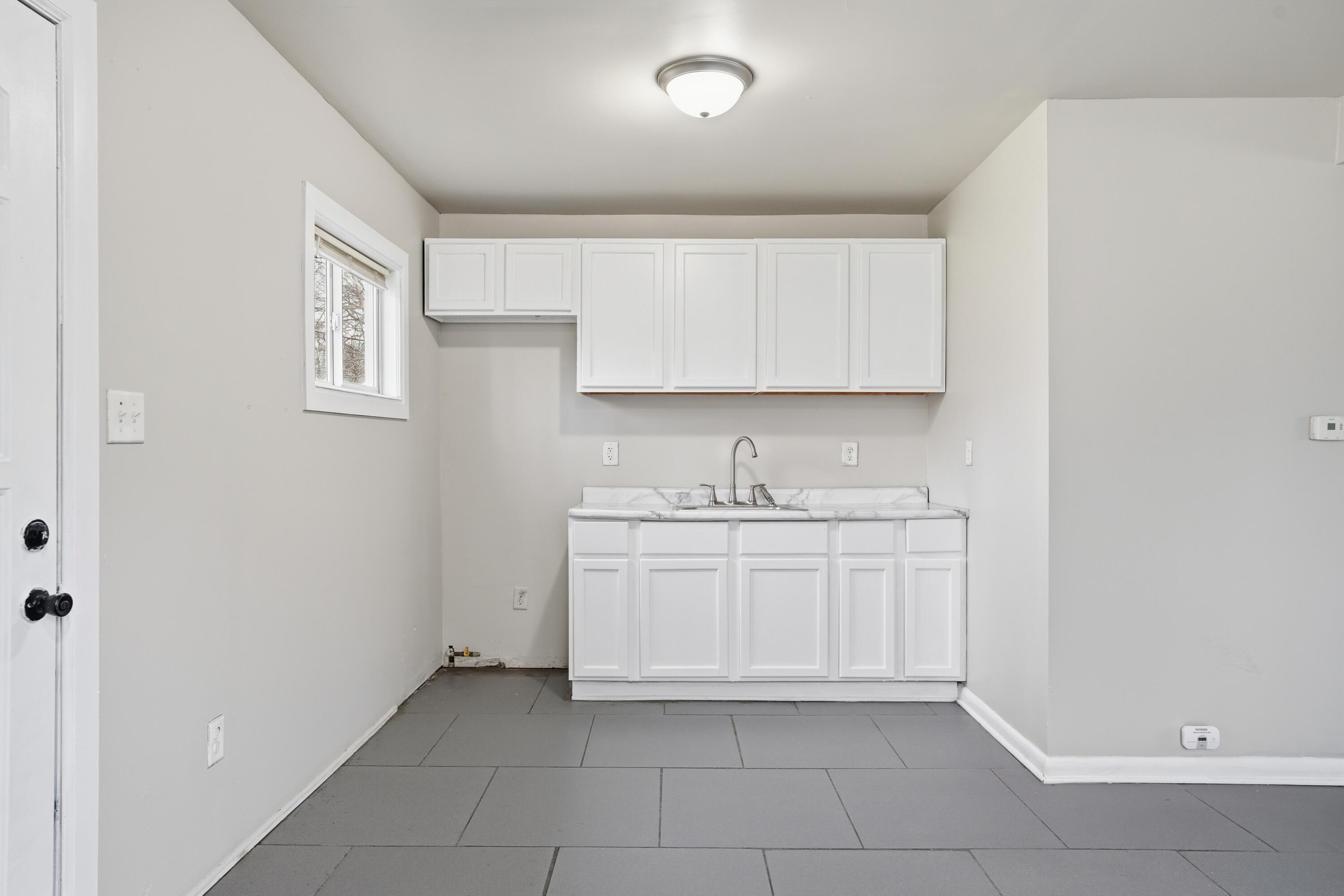 1075 Mount Street Gary, IN 46406 - Photo 10 of 11 a kitchen with a sink and cabinets