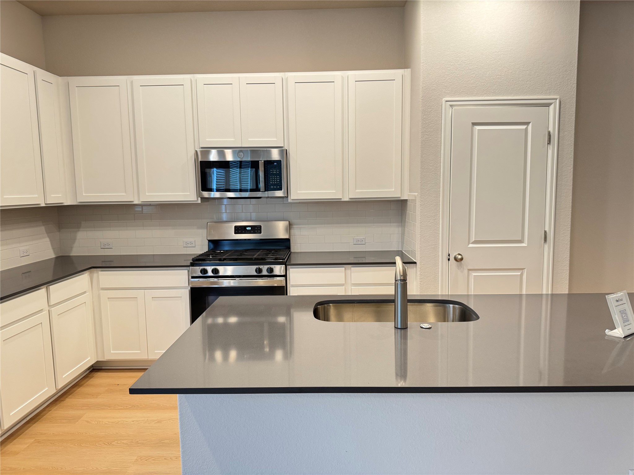 3000 Chisholm Trail Road, Unit 3 Round Rock, TX 78681 - Photo 2 of 28 a kitchen with granite countertop a sink a stove and cabinets