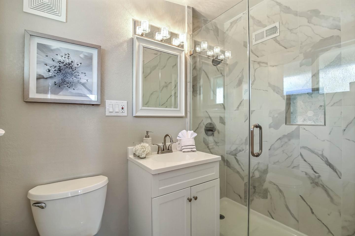 18911 Arata Way Cupertino, CA 95014 - Photo 11 of 18 a bathroom with a toilet sink and mirror