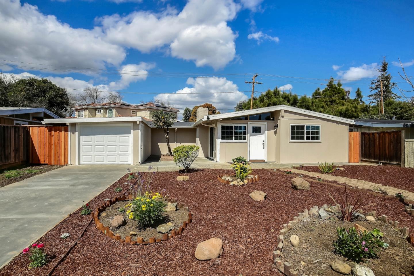 18911 Arata Way Cupertino, CA 95014 - Photo 15 of 18 a front view of a house with garden