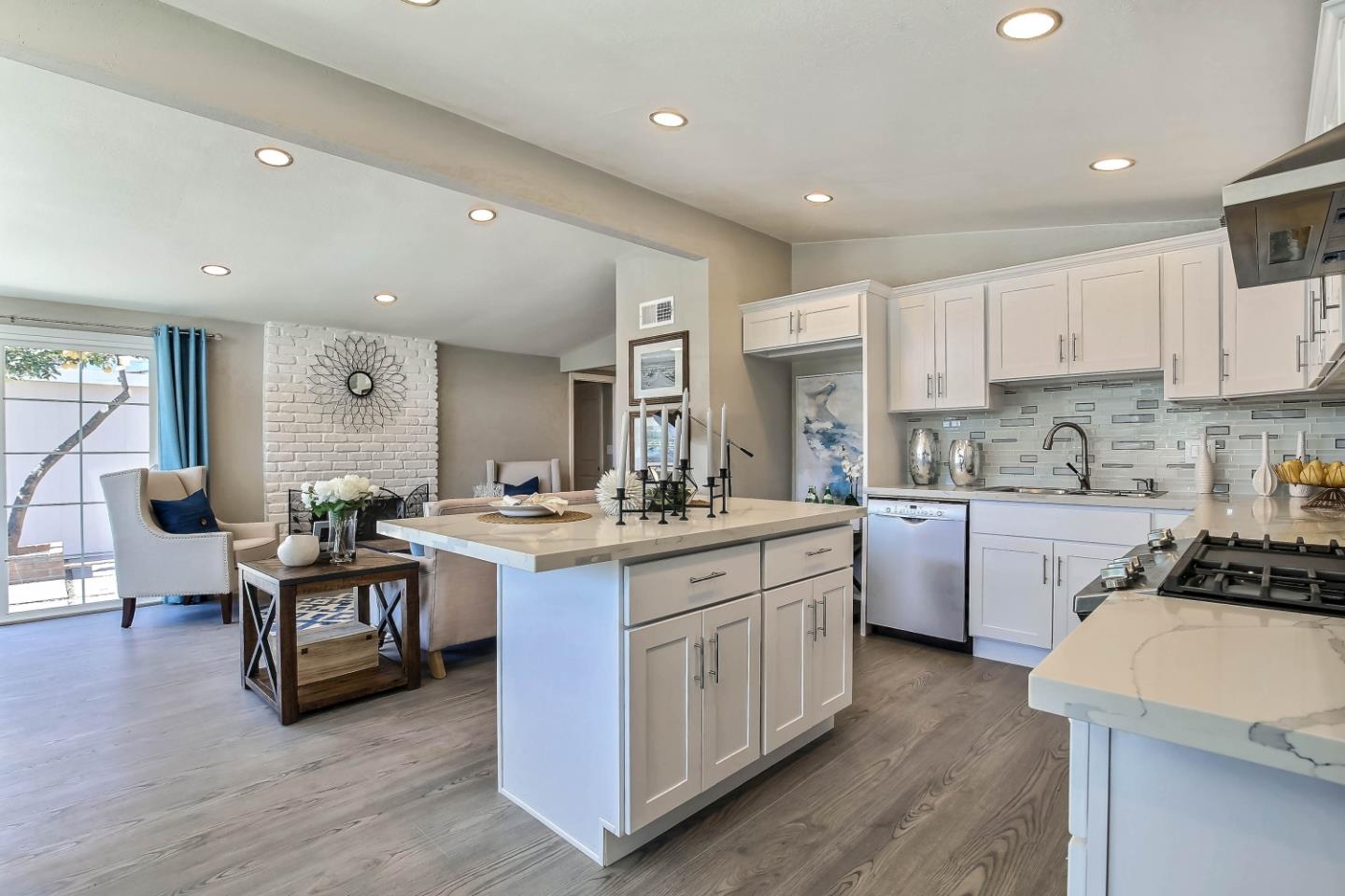 18911 Arata Way Cupertino, CA 95014 - Photo 6 of 18 a kitchen with kitchen island granite countertop wooden cabinets and white appliances