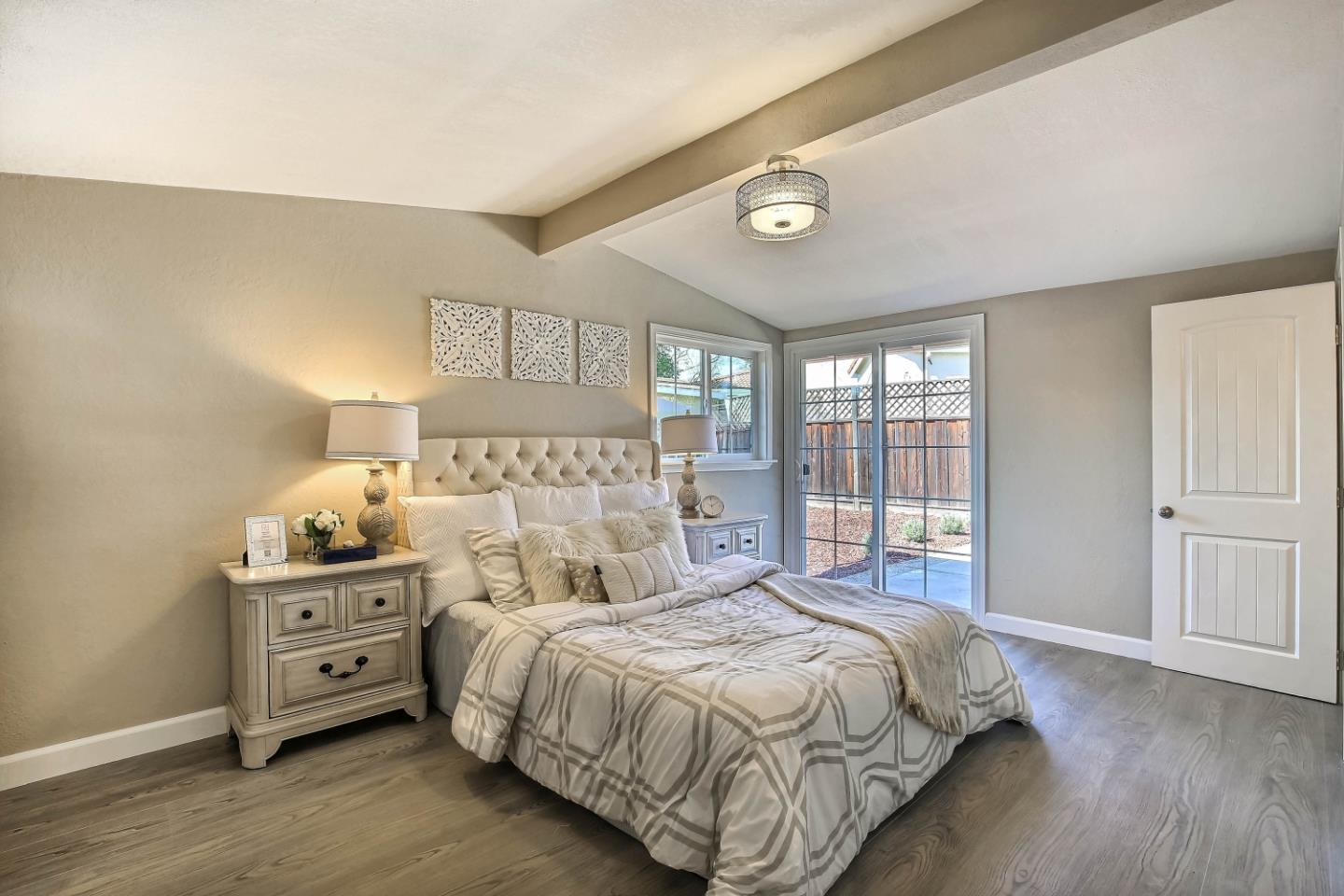18911 Arata Way Cupertino, CA 95014 - Photo 9 of 18 a bedroom with a bed and a tv on the dresser