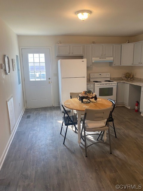 142 Samford Street Alberta, VA 23821 - Photo 4 of 24 a table and chairs in a kitchen with kitchen island white wooden cabinets and wooden floor