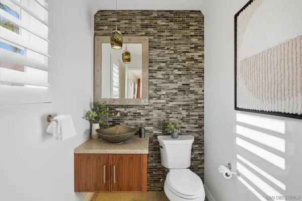 a bathroom with a toilet a sink and tub