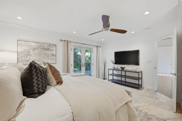 a bedroom with a bed and a flat screen tv