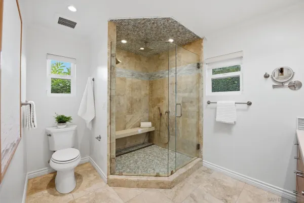 a bathroom with a toilet and a shower