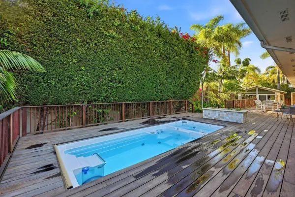 a view of a wooden deck with a yard