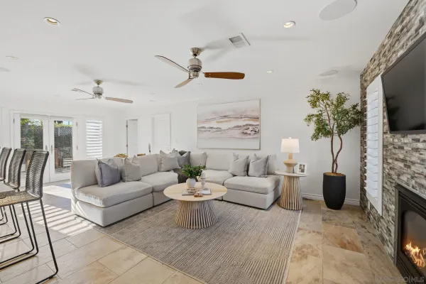 a living room with furniture a flat screen tv and a fireplace