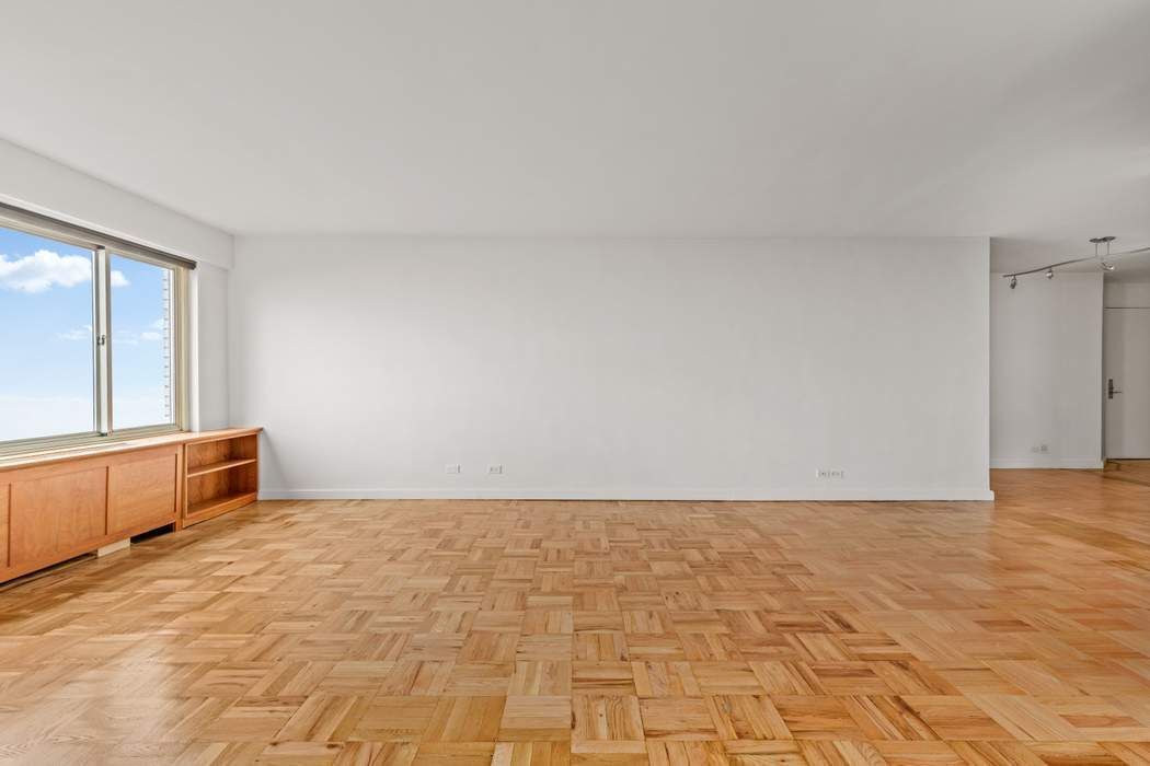 60 Riverside Drive, Unit 19C Manhattan, NY 10024 - Photo 13 of 16 a view of an empty room and window
