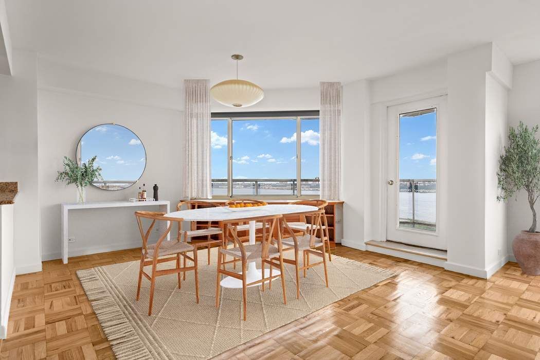 60 Riverside Drive, Unit 19C Manhattan, NY 10024 - Photo 2 of 16 a view of a dining room with furniture and window