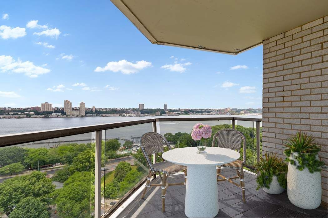 60 Riverside Drive, Unit 19C Manhattan, NY 10024 - Photo 3 of 16 a balcony with table and chairs and potted plants