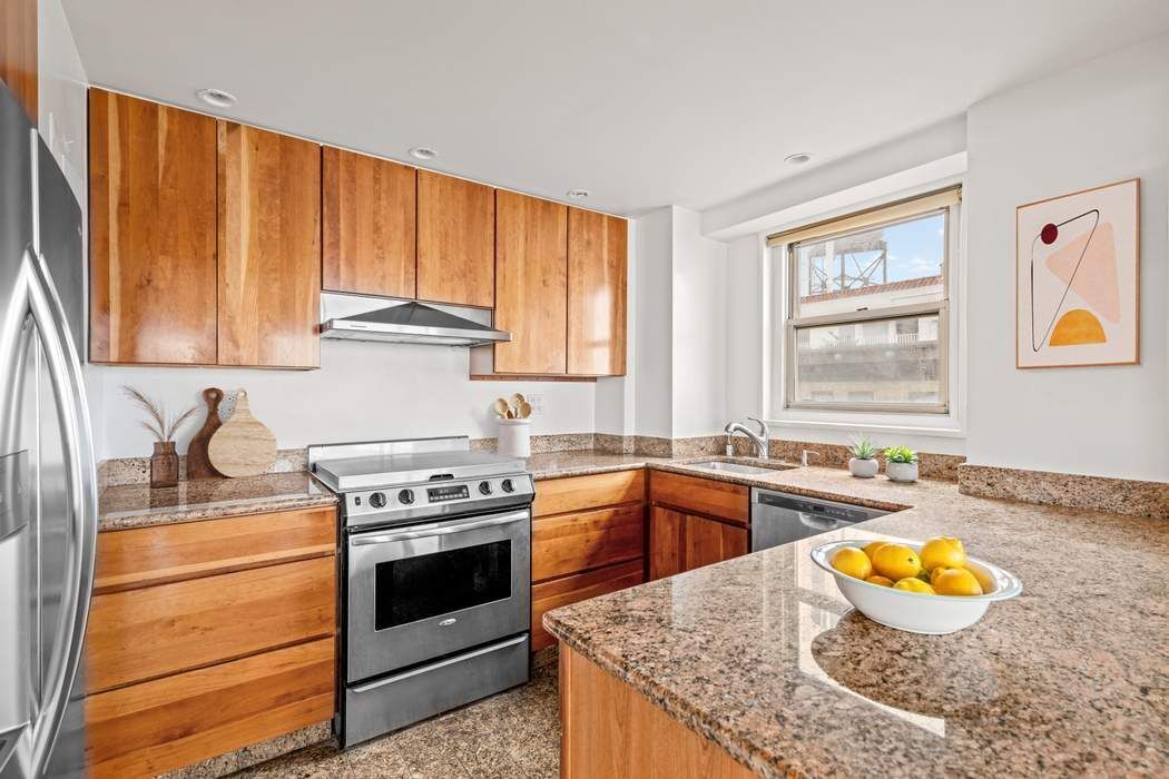 60 Riverside Drive, Unit 19C Manhattan, NY 10024 - Photo 5 of 16 a kitchen with a stove a sink and a cabinets