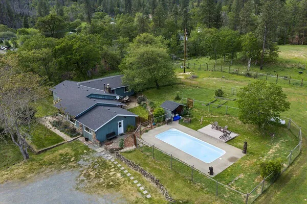 an aerial view of a house with a yard
