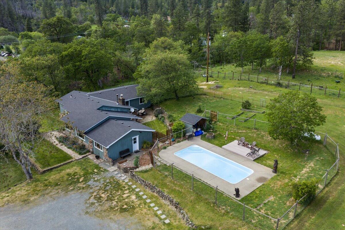 an aerial view of a house with a yard